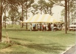 Party under a yellow and white awning at the Boynton Beach golf course, c. 1987