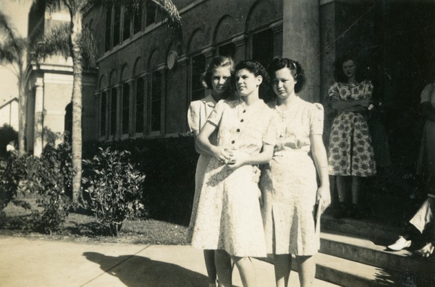 Three young women in front of Boynton High School, 1942