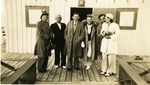 Group of three Couples Standing in Front of a Stiltsville Building