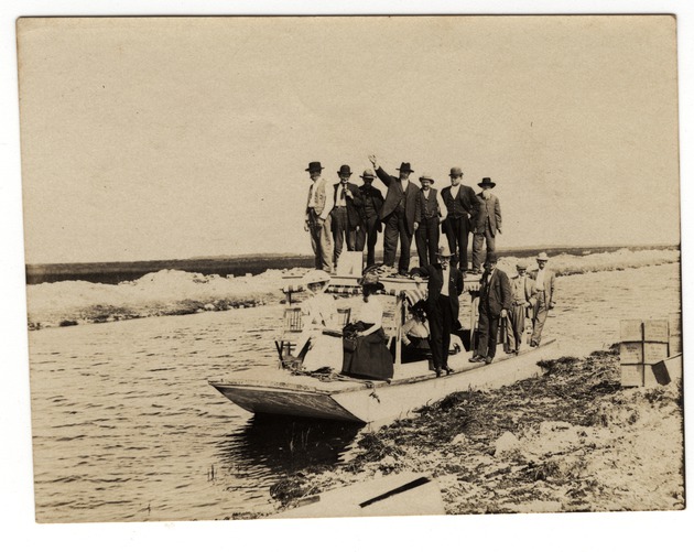 People Standing and Seated on Small Boat in Canal Near Davie, Fla