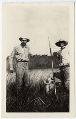 [1913] Two Men With Skiff on Waterway Bank in the Everglades