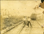 Two Crewmen Standing on the Wooden Train Track