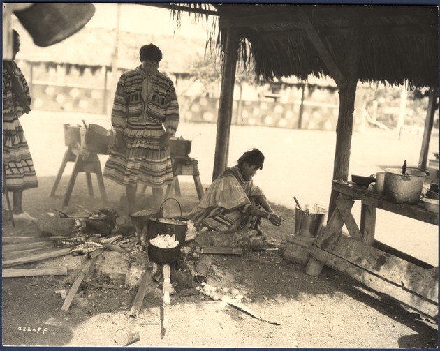 Seminole Woman and Men at a Cooking Fire