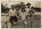 Family on Pier in Front of House