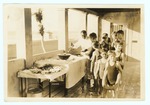 Waiter Serving Punch to Children Wearing Bathing Suits