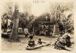 [1928-06-13] Seminoles Seated in Chickee and by Unlit Fire