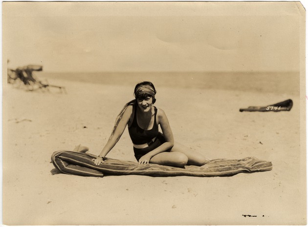 Woman Seated on Beach Mattress