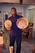 Ezequiel Torres holding batá drums