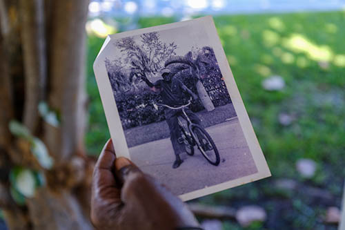 Nate Donaldson holding a photo of himself years back