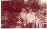 Alberta and Elmore Kerkela sitting on a bench with Dade County Mayor Steve Clark in Arch Creek Park