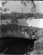 Two women standing on natural bridge in Arch Creek Park, North Miami