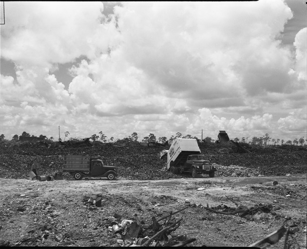 Dump trucks of the town of North Miami working at landfill site
