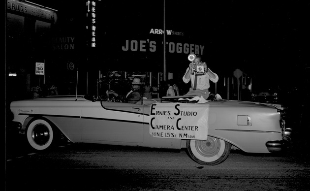 Convertible car with Ernie's Studio & Camera Center banner