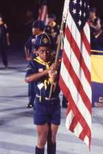 [1976-1977] Cub scout carries the American flag at the North Miami Bicentennial Parade