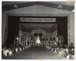 Contestants for Miss North Miami Pageant posing in their swimsuits on stage