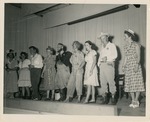 Corns-a-Poppin cast members line up on stage at W. J. Bryan Elementary School