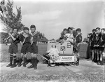 Cub Scout no. 45 line up with Ray's Amoco float to start parade, 1952