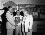 [1957-07-09] Miami Police Chief Walter Headley presents the 1956 Police Traffic Supervision Award to North Miami Police Chief Engel