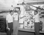 [1958-06-30] Firefighter showing public fire engine truck