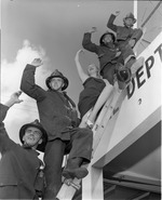 [1954-10-04] Firefighters and a lady waving goodbye pose on ladder at the North Miami Fire Station