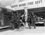 [1954-10-04] Firefighters and a lady pose by engine at the North Miami Fire Station No.1