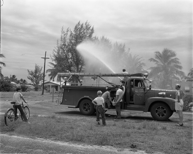 Mosquito Control Department using a fire truck to spray repellant on a neighborhood in North Miami