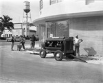 [1955-11-12] Construction crew using a jackhammer to repair a sidewalk in North Miami