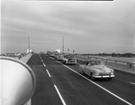 Cars drive across Broad Causeway Bridge during the opening ceremony