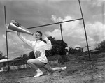 [1959-06-08] Young lady wearing North Miami varsity sweater and holding a megaphone