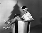 [1959-06-08] Young lady coming out of a Christmas present box