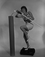 [1959-06-08] Young lady lighting a large candle
