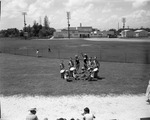 [1958-07-31] Baton twirling majorettes and drum Corps exercising on a school field