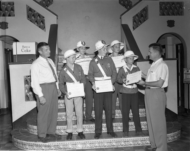 Group of children receiving Certificates of appreciation for their participation at the Kiwanis "Drive with Care" campaign