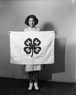Dolores Palomino holding a 4-H flag