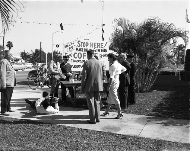 Police officer and firefighter serving coffee for the 1957 Coffee Break Safety Program