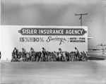 [1957-10-31] Children in Halloween costumes pose for a picture by Sisler Insurance Agency in North Miami