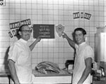 [1953-05-12] John Stratman and Grant pointing out signs of Chamber of Commerce and Jaycees