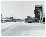 [1960-07-08] Street view with retail shops along Biscayne Blvd. and 127 Street
