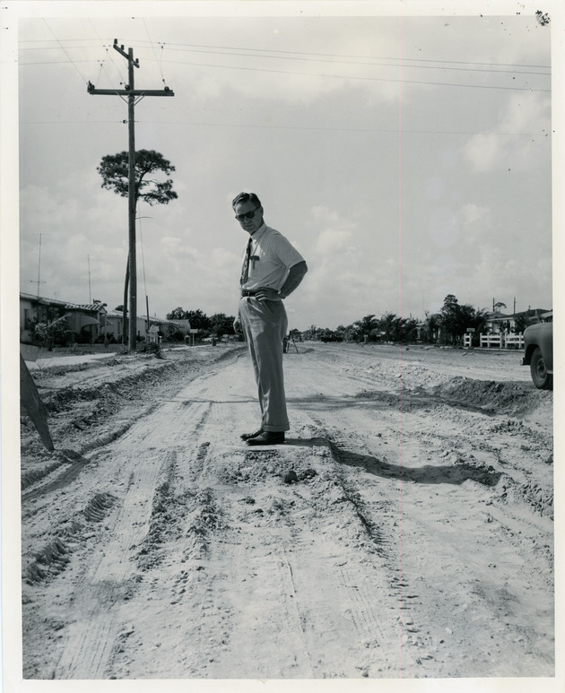 Police chief Thurman standing on street construction of NW 127 Str. and 7 Ave.