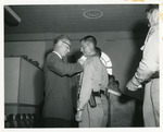 [1960-11-04] North Miami Police chief, Wayne Thurman, pins new officers with their badge