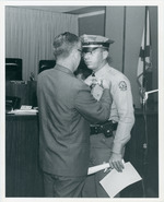 [1966-02-01] North Miami Police chief, Wayne Thurman, pinning new officers with his badge
