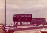 Ride to the Hounds Biscayne Dog Track billboard sign with Drive-In-Theatre building in the background
