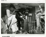 US Army Special Forces soldier and his South Vietnamese counterpart loading Minigun ammunition aboard a UH-1C Gunship helicopter.
