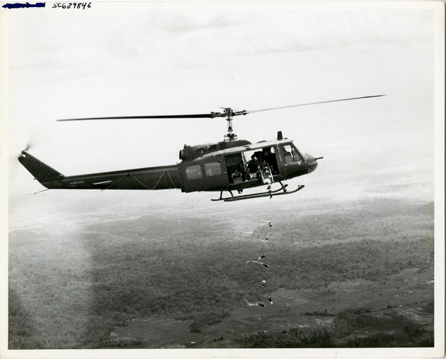 US Army UH-1B helicopter dropping mortar rounds in a test run bombing mission - 