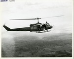 US Army UH-1B helicopter dropping mortar rounds in a test run bombing mission