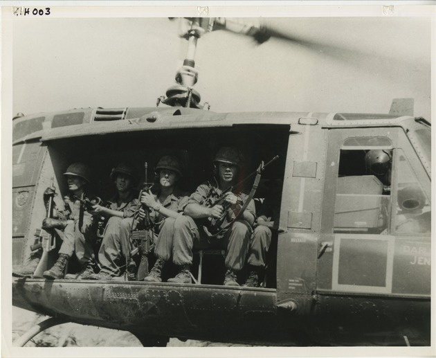 4 soldiers sit in helicopter - 