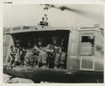 4 soldiers sit in helicopter