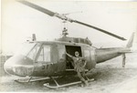 57th AHC Officer posing with helicopter