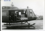 Troops sit in helicopter in the rain
