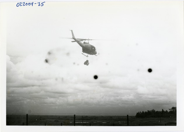 Helicopter flies while carrying barrels - 